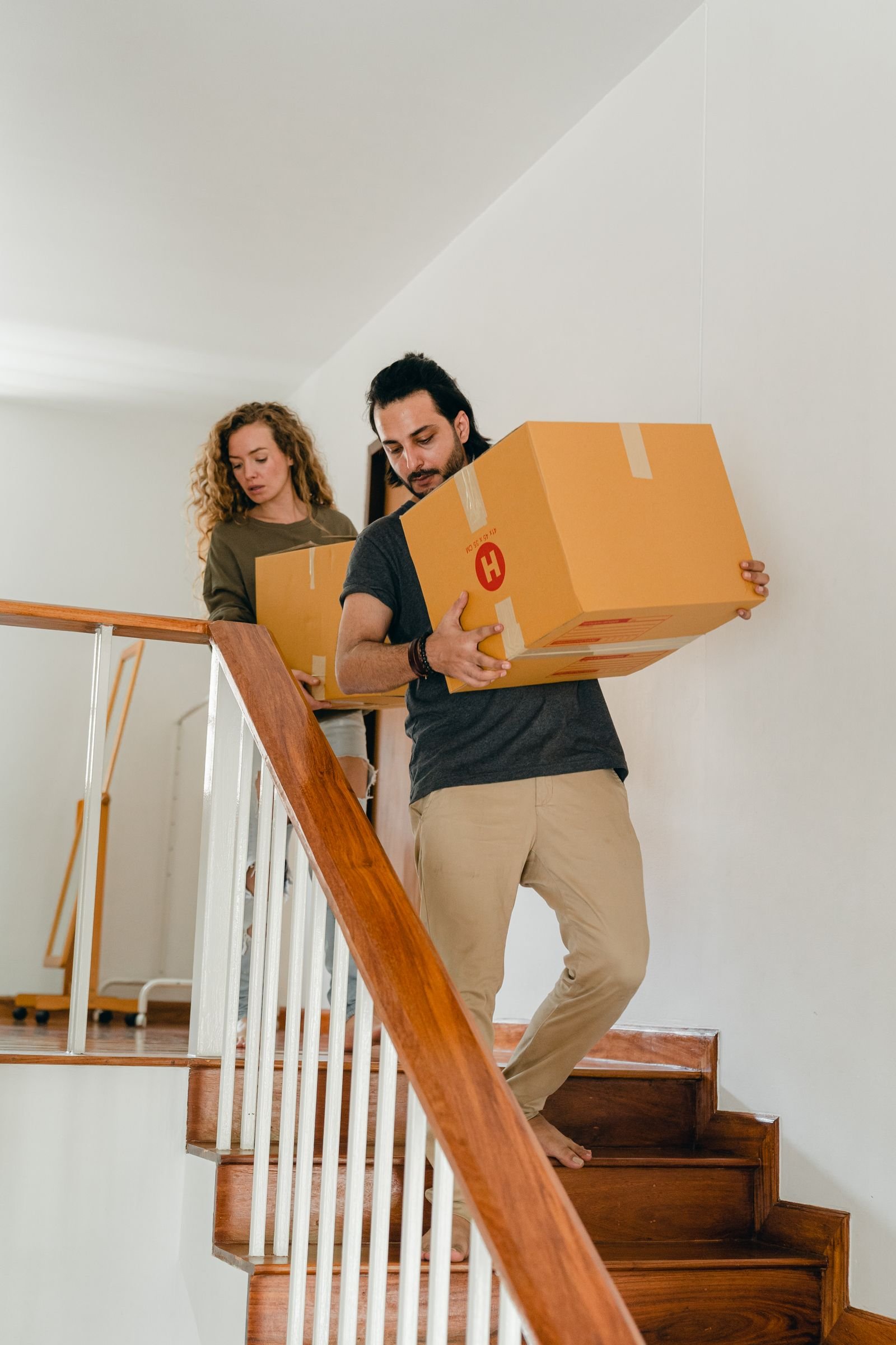 Cleaner preparing a home during a move, cardboard boxes visible in the background